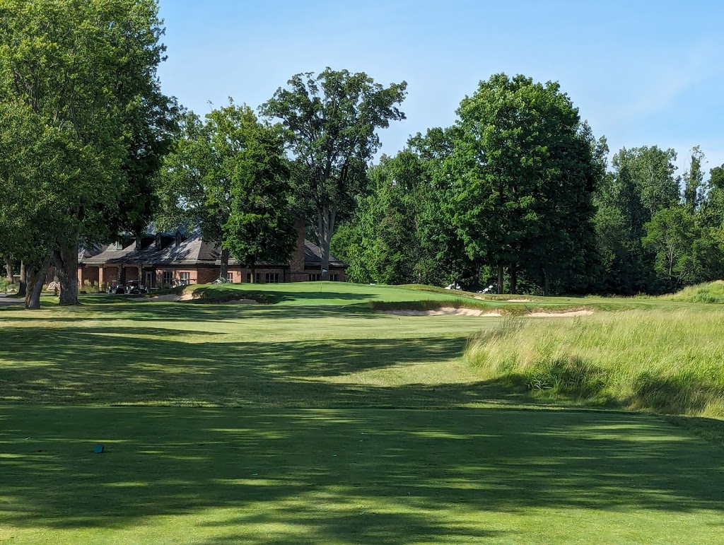 Panoramic view of a lush green golf course at Warren Golf Course. Smooth