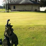 green grass with the flag in the hole.
