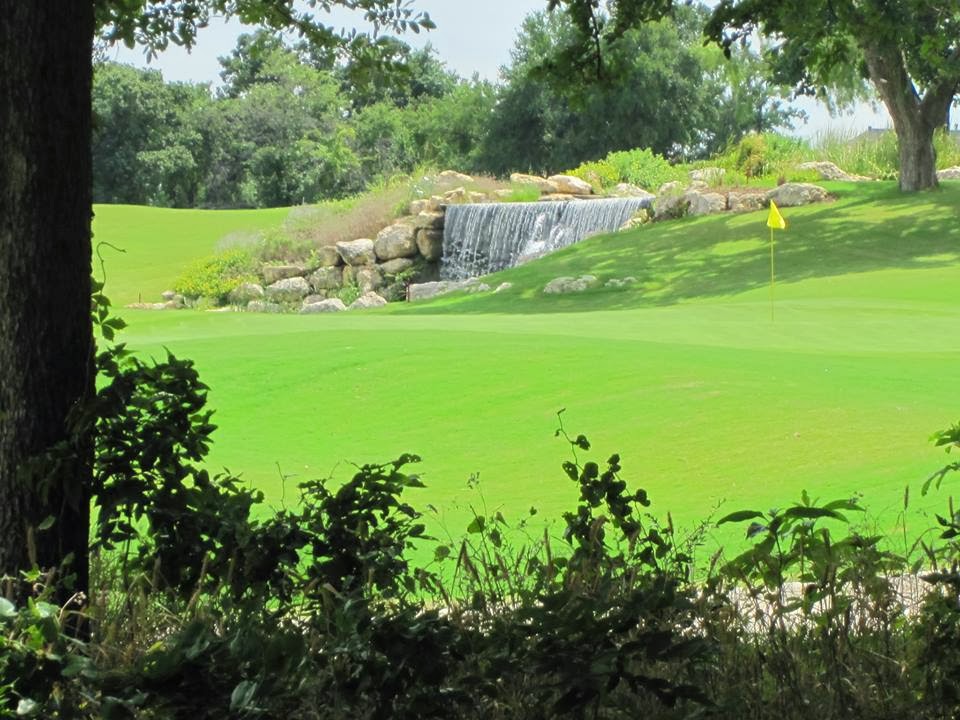 Panoramic view of a lush green golf course at Waterchase Golf Club. Smooth