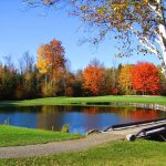 Panoramic view of a lush green golf course at Waterville Country Club. Smooth