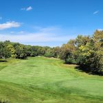 Panoramic view of a lush green golf course at WeaverRidge Golf Club. Smooth