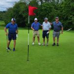green grass with the flag in the hole.