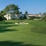 Panoramic view of a lush green golf course at Wee Burn Country Club. Smooth