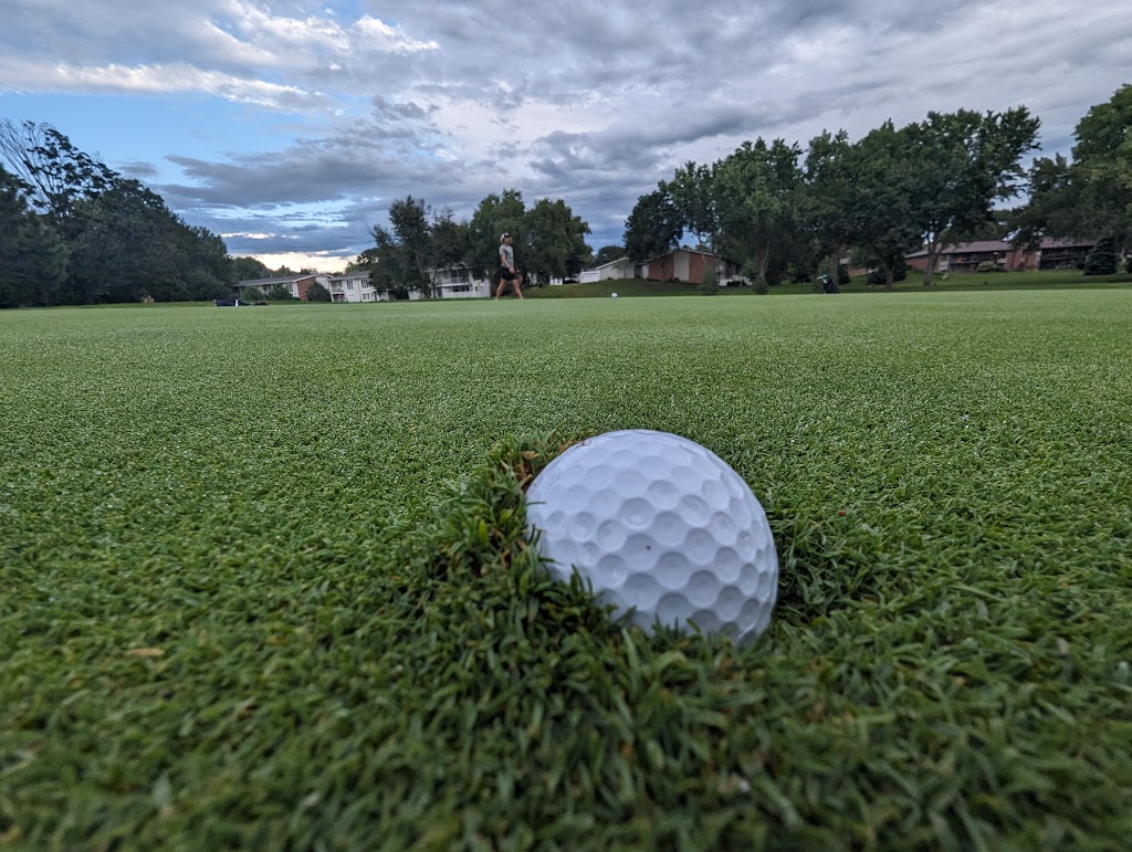 Panoramic view of a lush green golf course at Wellington Greens Golf Course. Smooth