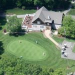 Panoramic view of a lush green golf course at Wentworth Hills Country Club. Smooth