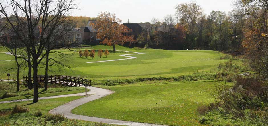 Panoramic view of a lush green golf course at West Chase Golf Club. Smooth