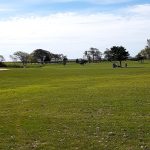 Panoramic view of a lush green golf course at West Sayville Golf Course. Smooth