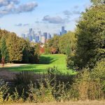 Panoramic view of a lush green golf course at West Seattle Golf Course. Smooth