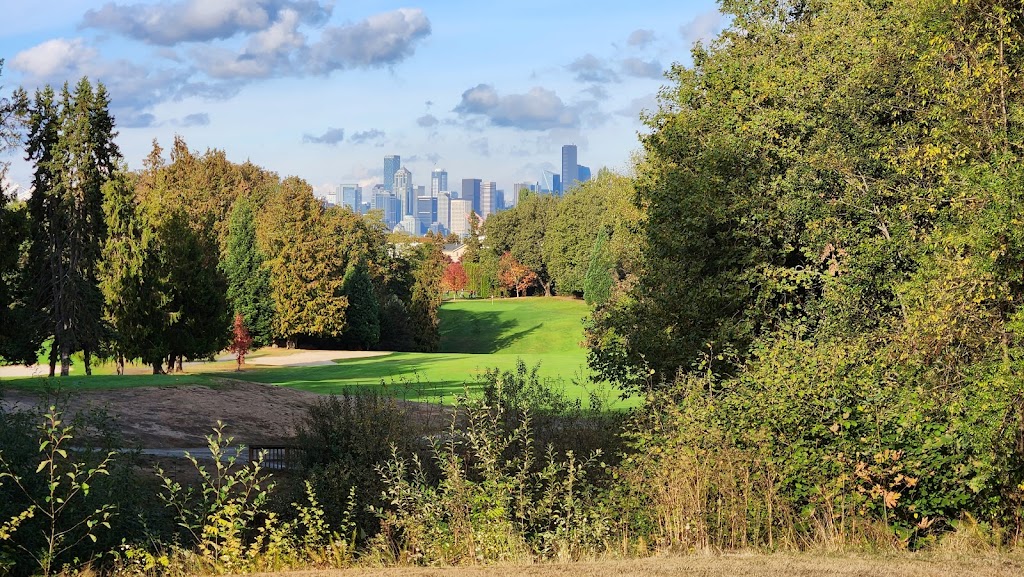 Panoramic view of a lush green golf course at West Seattle Golf Course. Smooth