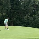 green grass with the flag in the hole.