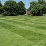 Panoramic view of a lush green golf course at Westwood Golf Course. Smooth
