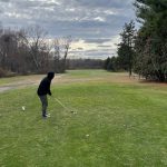 green grass with the flag in the hole.