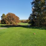 Panoramic view of a lush green golf course at Whaling City Golf Course. Smooth