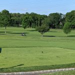 Panoramic view of a lush green golf course at Wheatley Hills Golf Club. Smooth