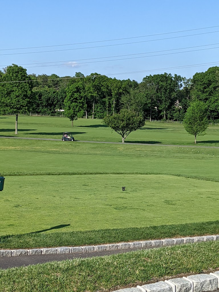 Panoramic view of a lush green golf course at Wheatley Hills Golf Club. Smooth