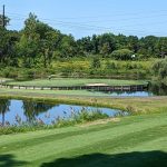 Panoramic view of a lush green golf course at Wheeler Family Traditions Golf Club. Smooth