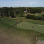 green grass with the flag in the hole.