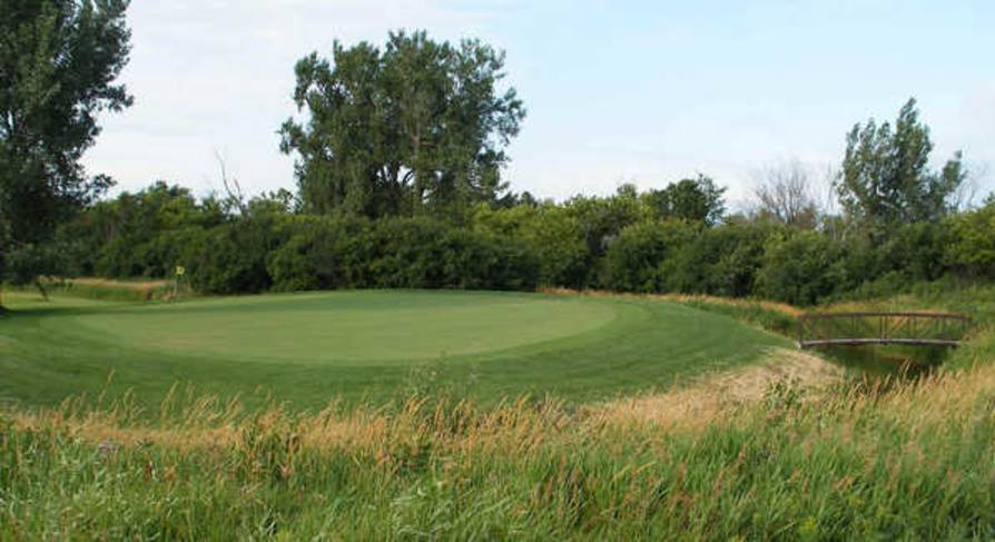 Panoramic view of a lush green golf course at Whetstone Creek Golf Course. Smooth