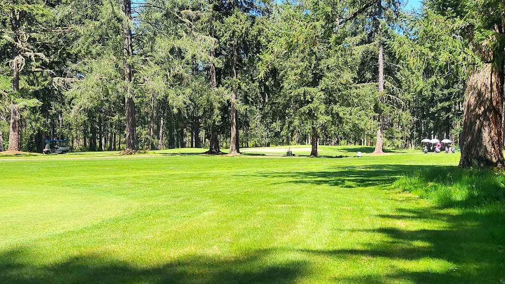 Panoramic view of a lush green golf course at Whispering Firs Golf Course. Smooth