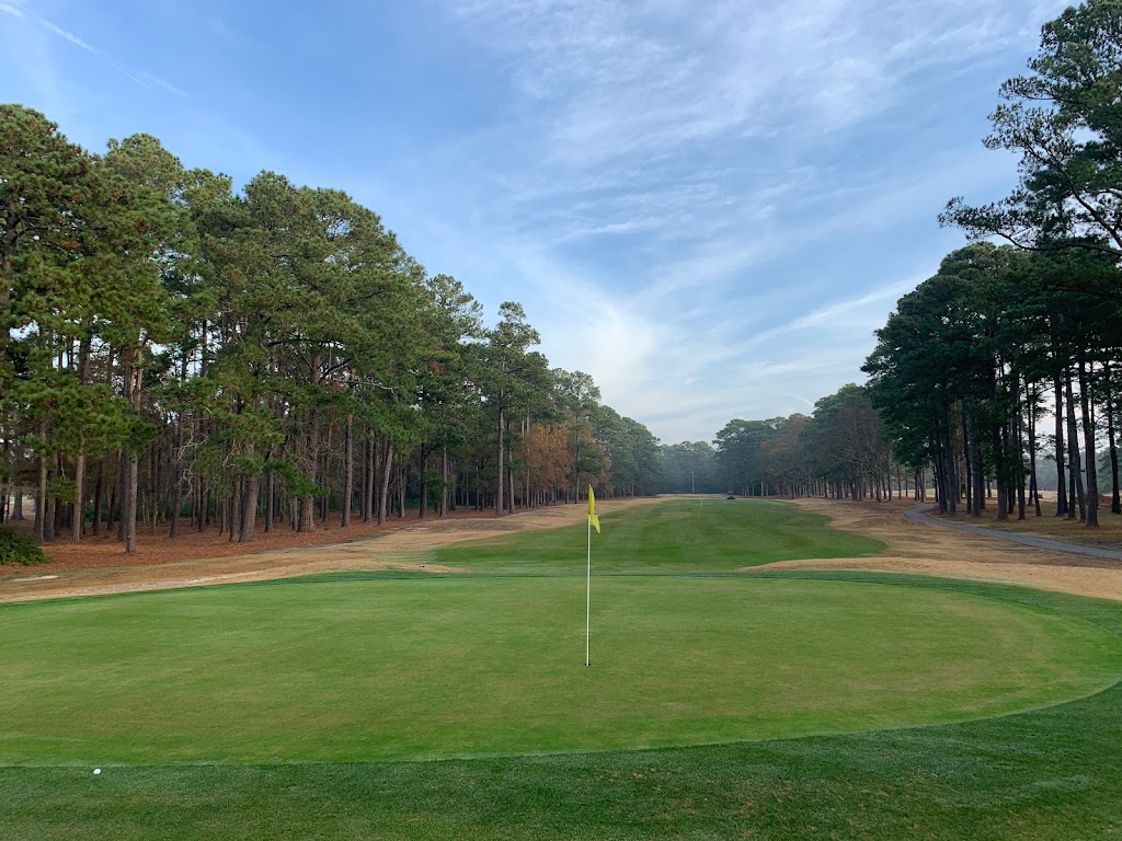 Panoramic view of a lush green golf course at Whispering Pines Golf Course. Smooth