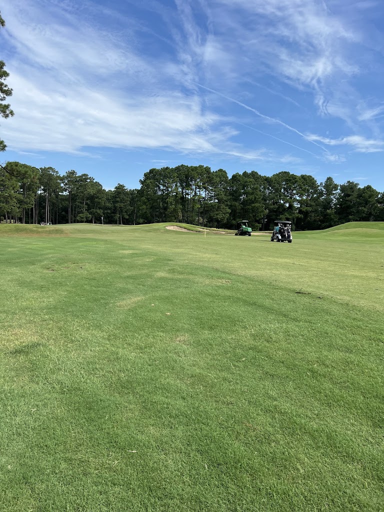 Panoramic view of a lush green golf course at Whispering Pines. Smooth