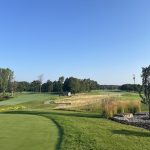 Panoramic view of a lush green golf course at Whispering Springs Golf Club. Smooth