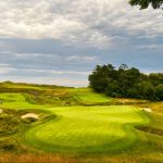 green grass with the flag in the hole.