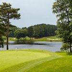 Panoramic view of a lush green golf course at White Columns Country Club. Smooth