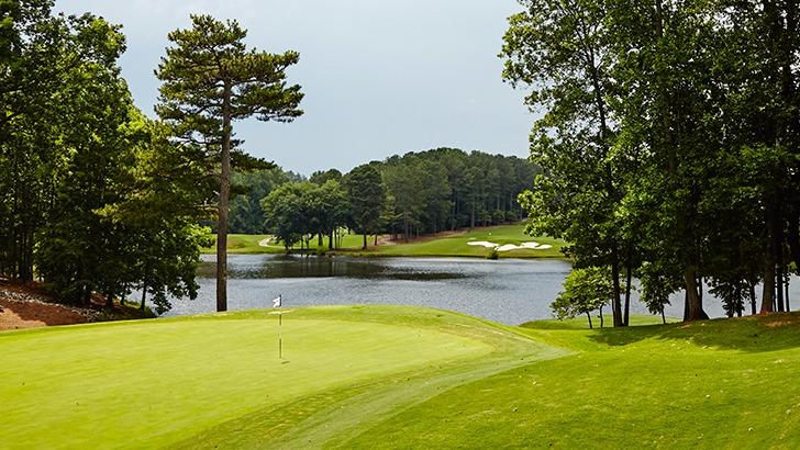 Panoramic view of a lush green golf course at White Columns Country Club. Smooth