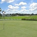 Panoramic view of a lush green golf course at White Heron Golf Club. Smooth
