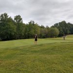 Panoramic view of a lush green golf course at White Plains Golf Course. Smooth
