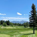 Panoramic view of a lush green golf course at Whitetail Club. Smooth