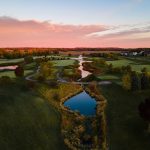Panoramic view of a lush green golf course at Whitetail Ridge Golf Club. Smooth