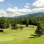 Panoramic view of a lush green golf course at Wild Laurel Golf Course. Smooth