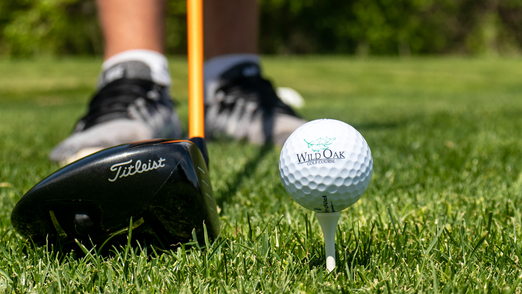 Panoramic view of a lush green golf course at Wild Oak Golf Course. Smooth