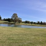 Panoramic view of a lush green golf course at Wild Turkey Trace. Smooth