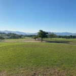 Panoramic view of a lush green golf course at Wildcreek Golf Course. Smooth