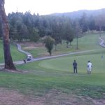 Panoramic view of a lush green golf course at Wildwood Golf Course. Smooth