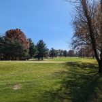 Panoramic view of a lush green golf course at Willow Brook Golf Course. Smooth