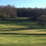 Panoramic view of a lush green golf course at Willow Creek Country Club. Smooth