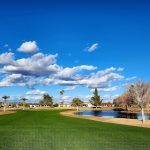 Panoramic view of a lush green golf course at Willow Creek Golf Course. Smooth