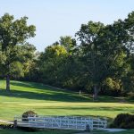 Panoramic view of a lush green golf course at Willow Creek Golf Course. Smooth