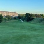 green grass with the flag in the hole.
