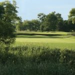 Panoramic view of a lush green golf course at Willow Run Golf Course. Smooth