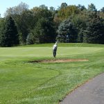 green grass with the flag in the hole.