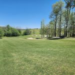 Panoramic view of a lush green golf course at Winding Creek Golf Course. Smooth