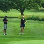 green grass with the flag in the hole.