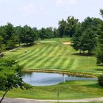 Panoramic view of a lush green golf course at Windridge Country Club. Smooth