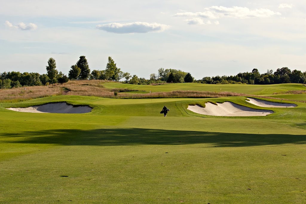 Panoramic view of a lush green golf course at Windsong Farm Golf Club. Smooth