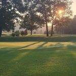 Panoramic view of a lush green golf course at Winn Mountain Golf Course. Smooth